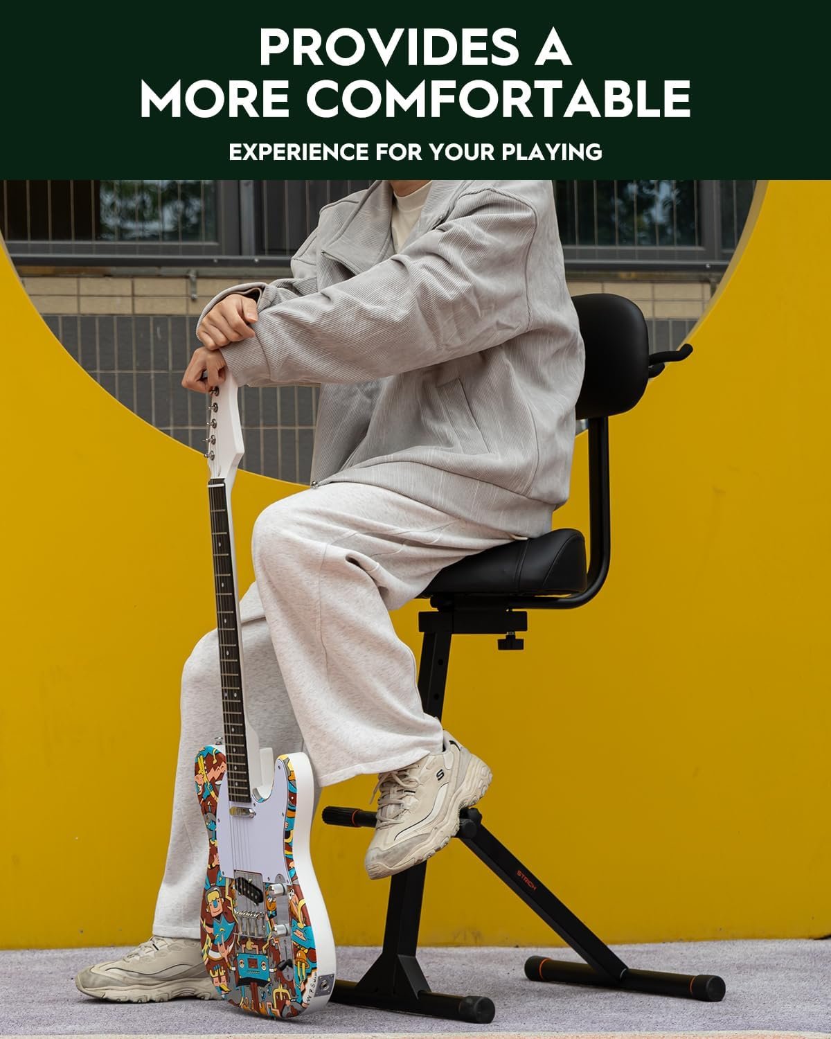 Guitarist working in a home studio with an organised playing setup