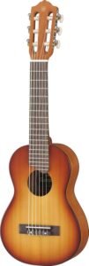 Yamaha GL1 Guitalele in Tobacco Sunburst finish resting on a practice room chair