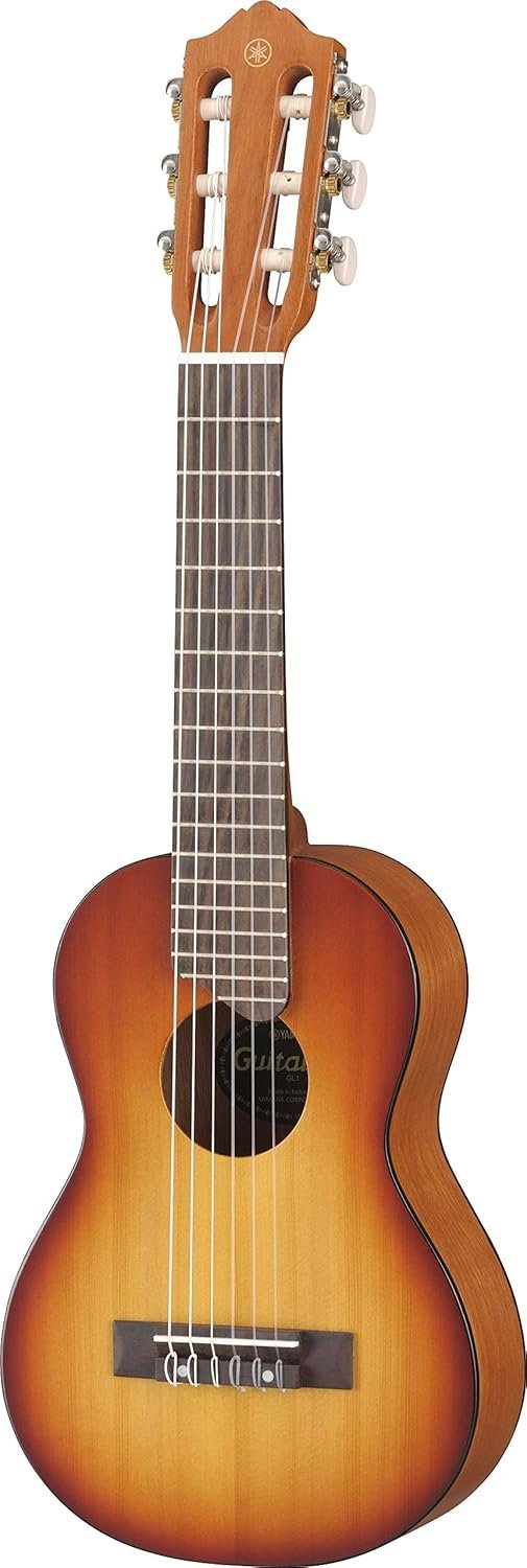 Yamaha GL1 Guitalele in Tobacco Sunburst finish resting on a practice room chair